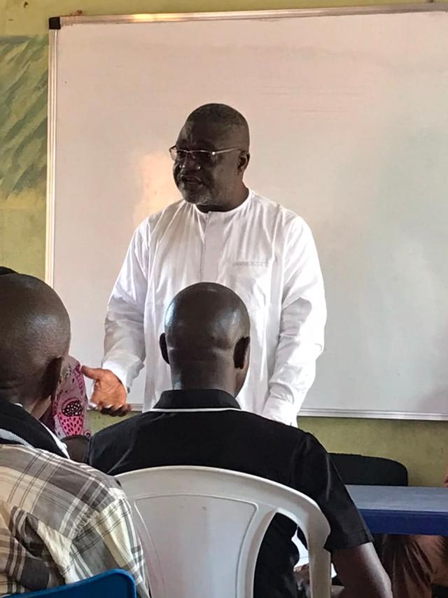 The proprietor, Emmanuel I. Hangerior, speaking to staff at a meeting in one of the classrooms
